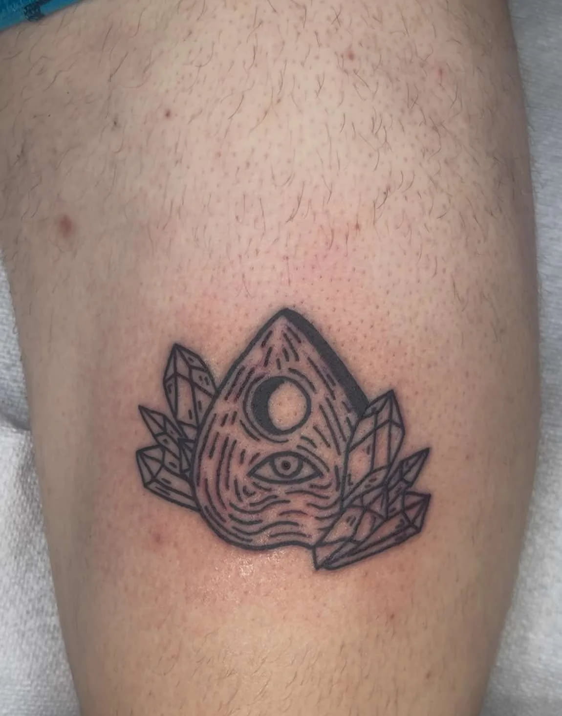 Fine line all-seeing eye tattoo with geometric crystals and mystical design