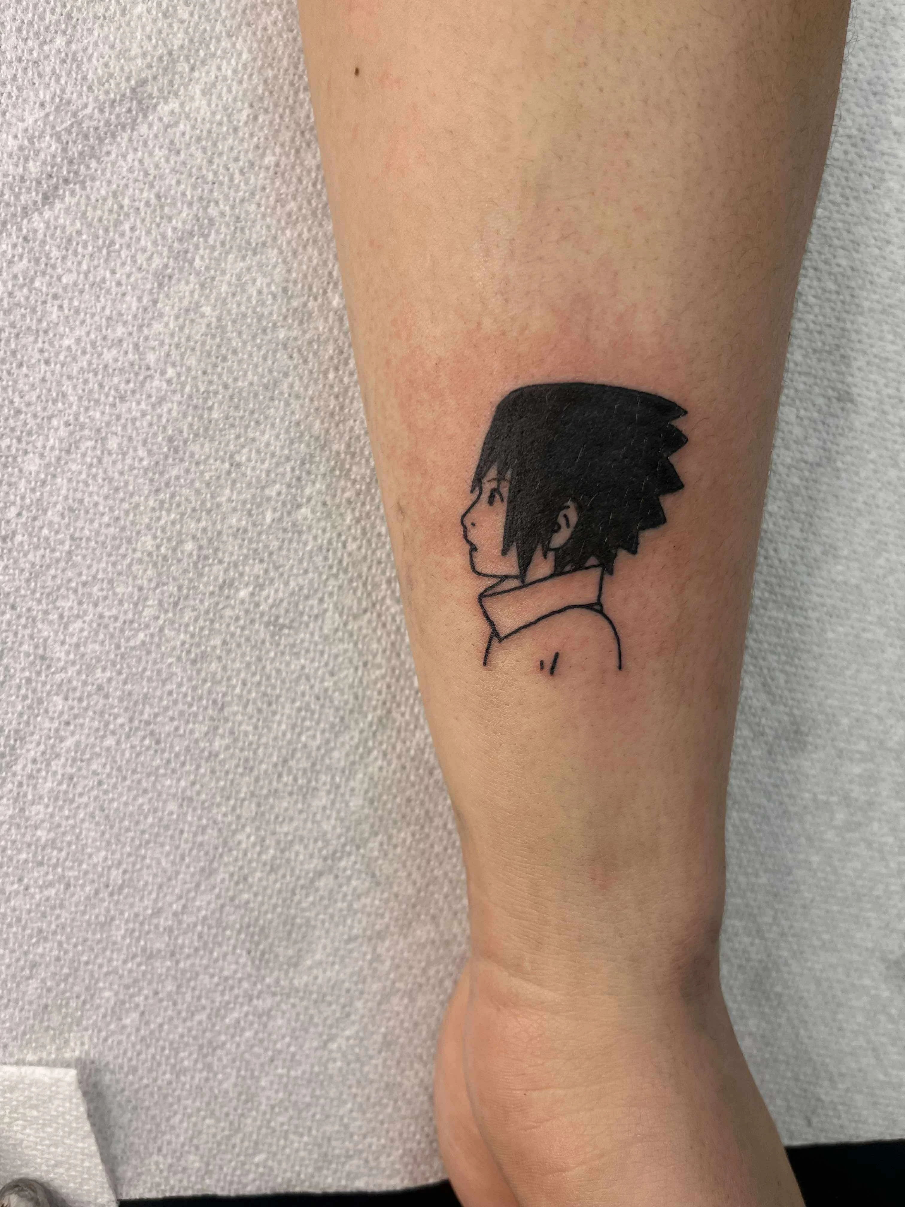 Fine line anime character portrait tattoo with detailed facial features