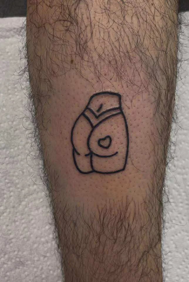 Fine line boxing glove tattoo with simple outline and sports theme