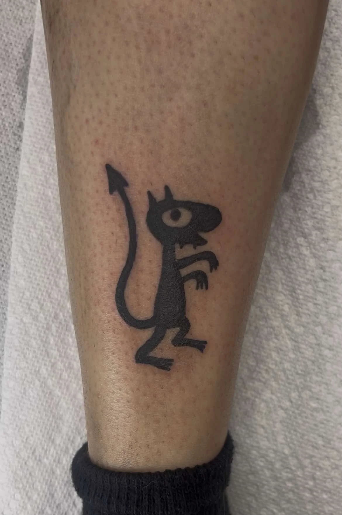 Fine line cartoon devil tattoo with cute design and minimalist linework