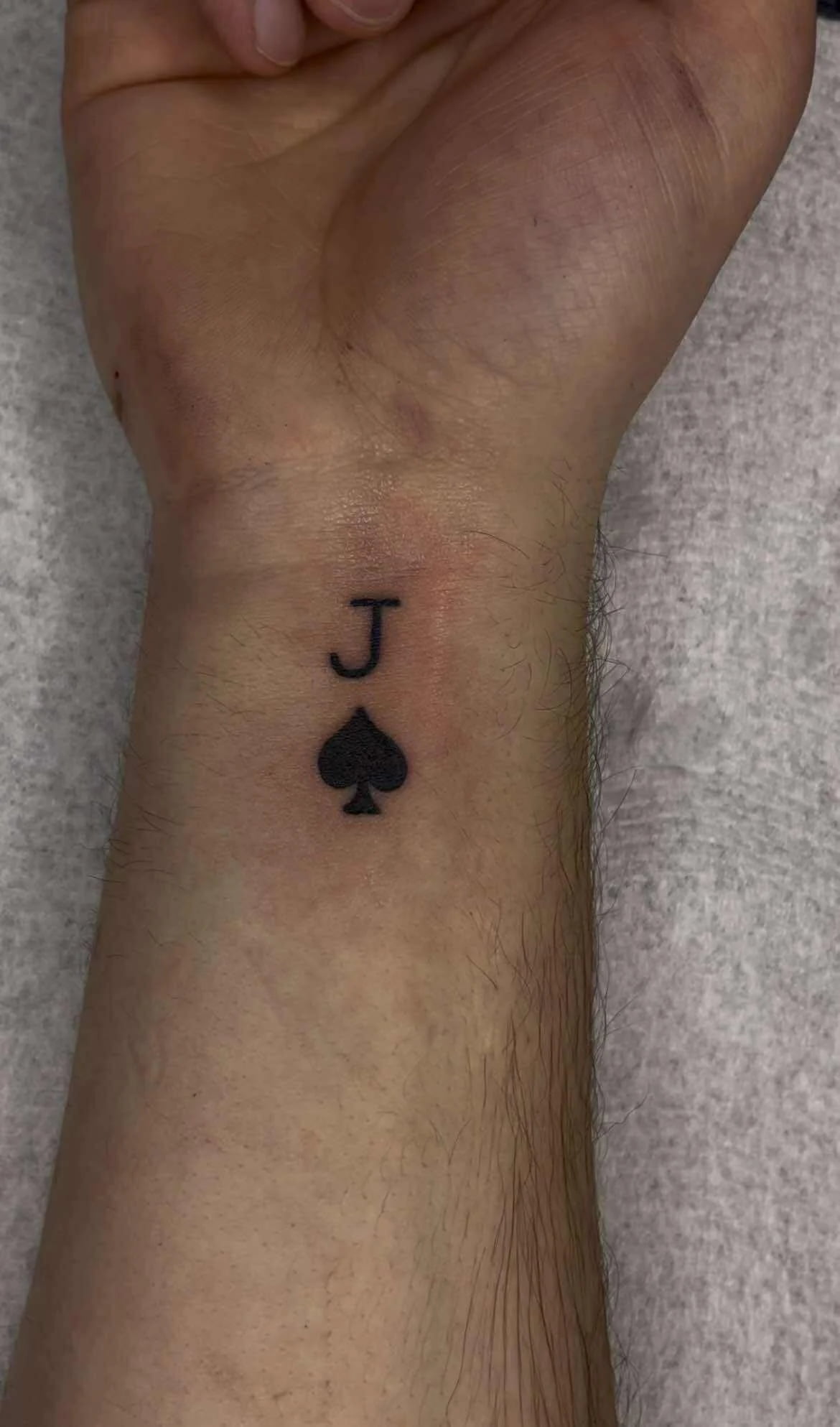 Fine line Jack of Spades playing card tattoo with clean minimalist design