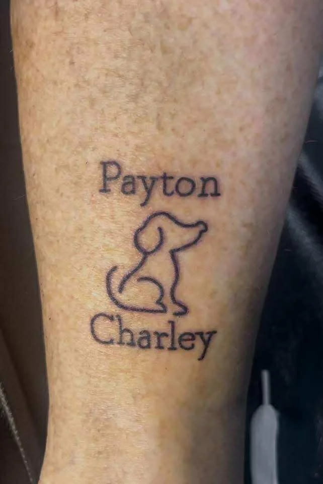 Fine line pet memorial tattoo with dog silhouettes and loving tribute design