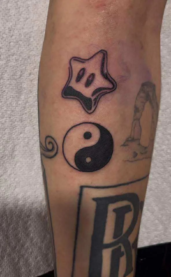 Fine line star face yin yang with letter R tattoo spiritual symbolic design