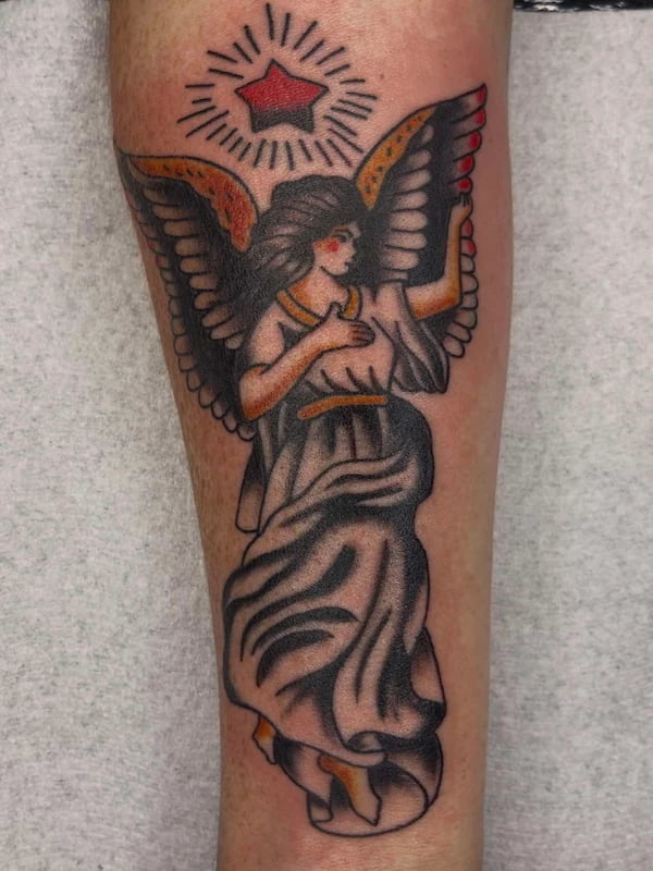 Traditional angel tattoo with wings and classic American traditional styling