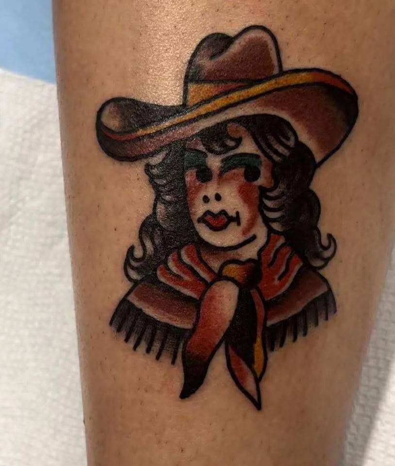 Traditional cowgirl portrait tattoo with western themed elements