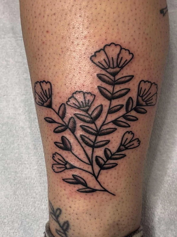 Traditional floral branch tattoo with simple black line work flowers and leaves