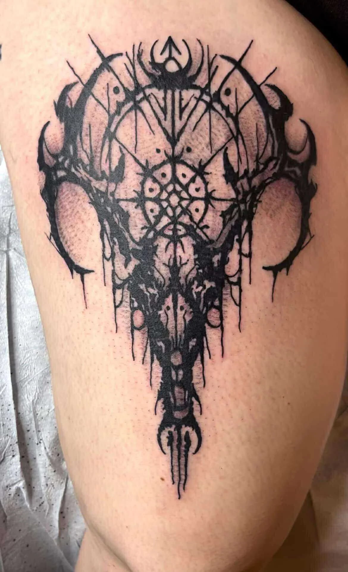 Traditional geometric skull tattoo with pattern work and bold design