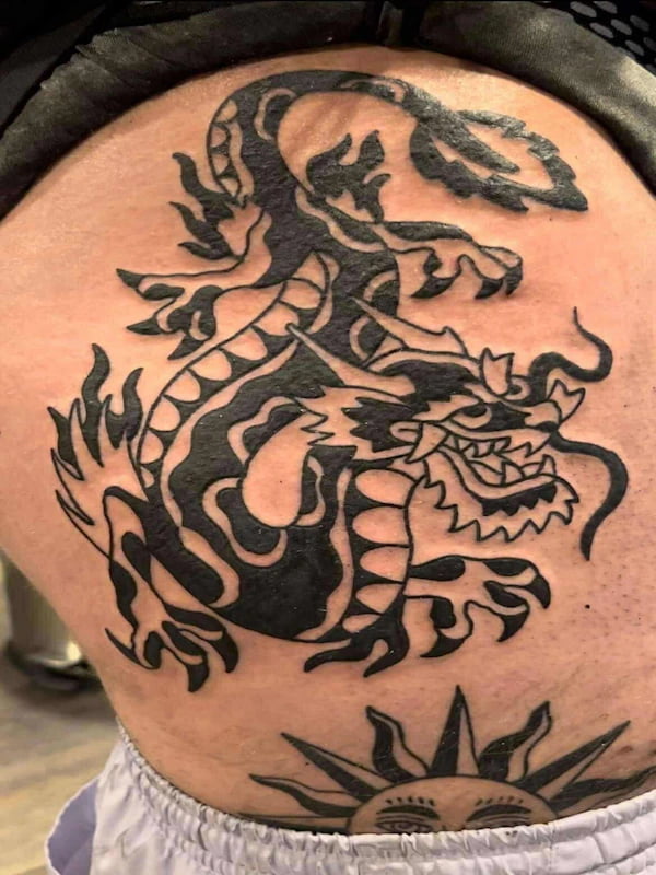 Traditional Japanese style dragon tattoo with bold black design and flames