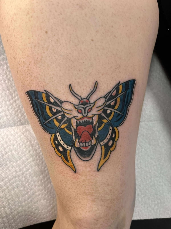 Traditional moth and tiger combination tattoo with bold traditional styling
