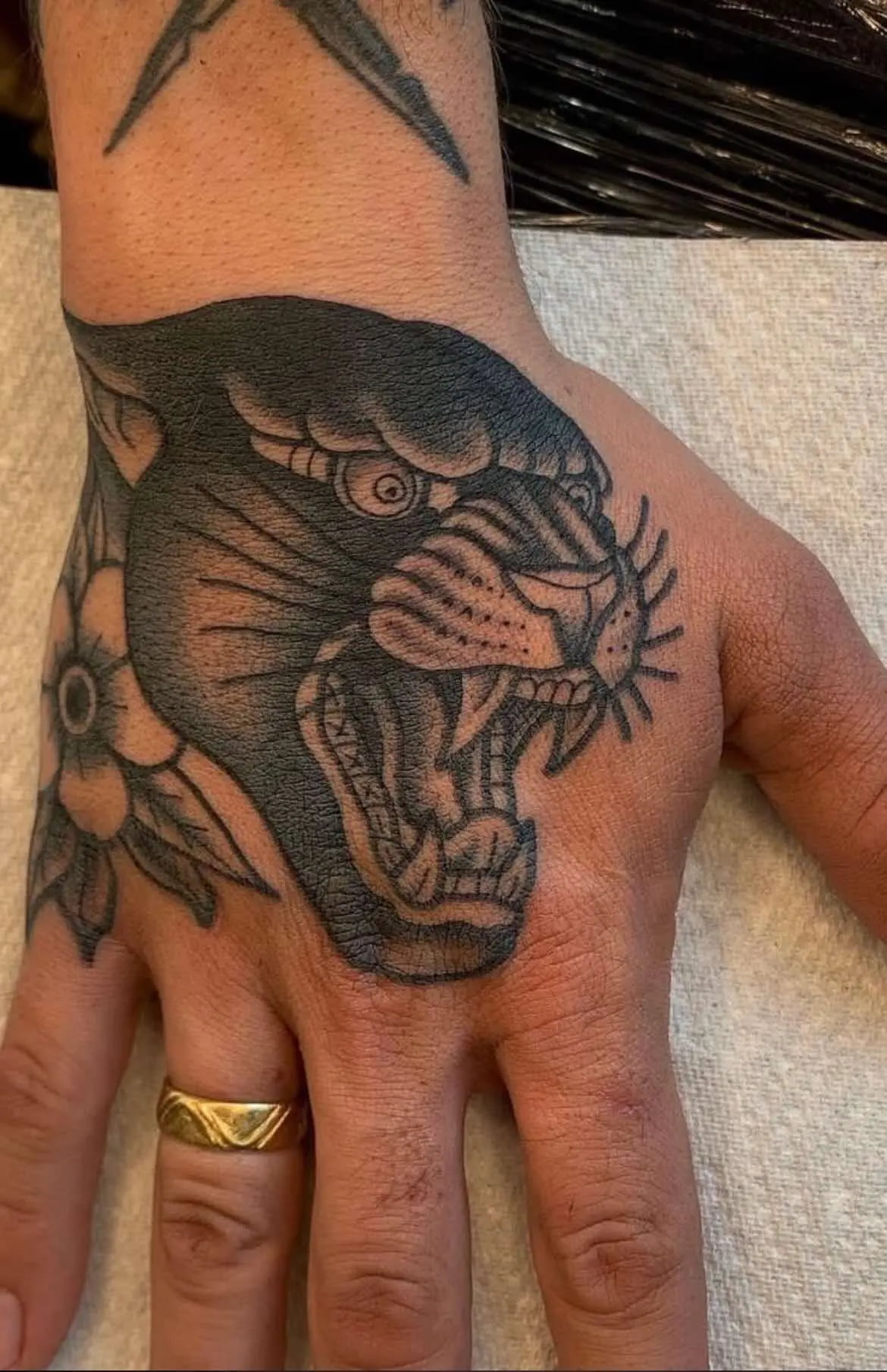 Traditional panther tattoo with fierce expression and bold black work