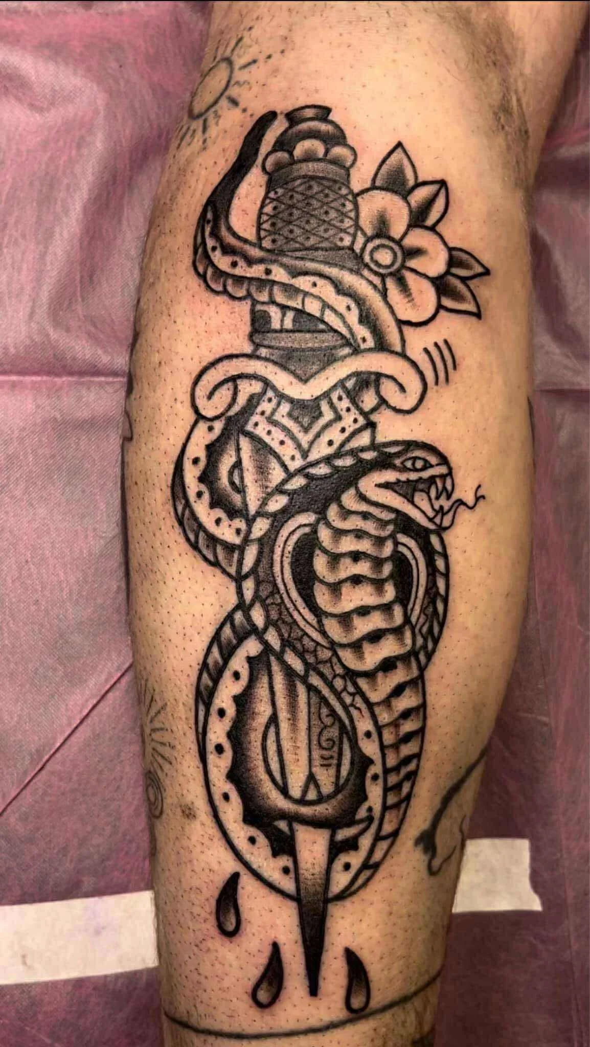 Traditional sacred heart tattoo with religious symbolism and flames