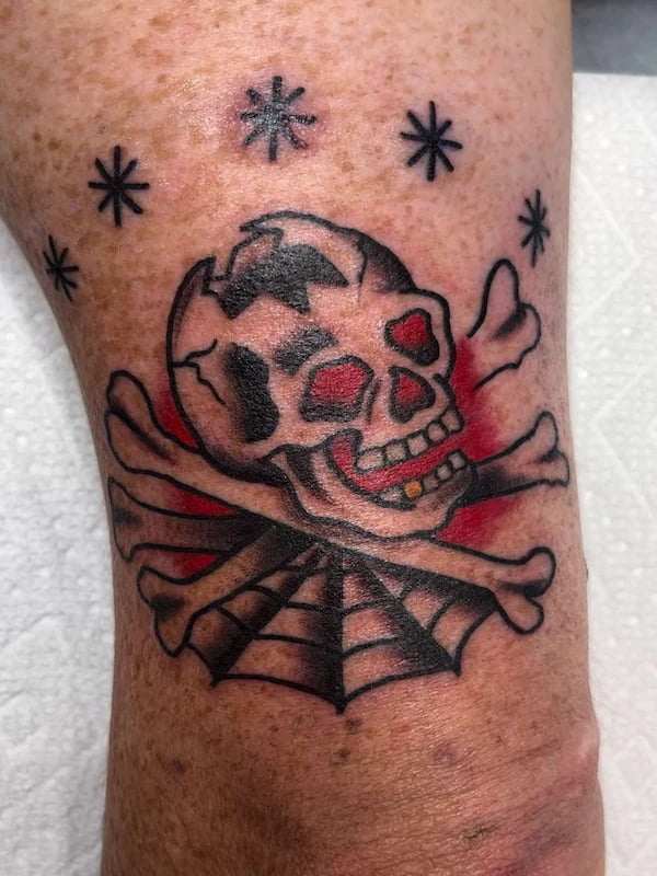 Traditional skeleton and spider web tattoo with dark gothic elements